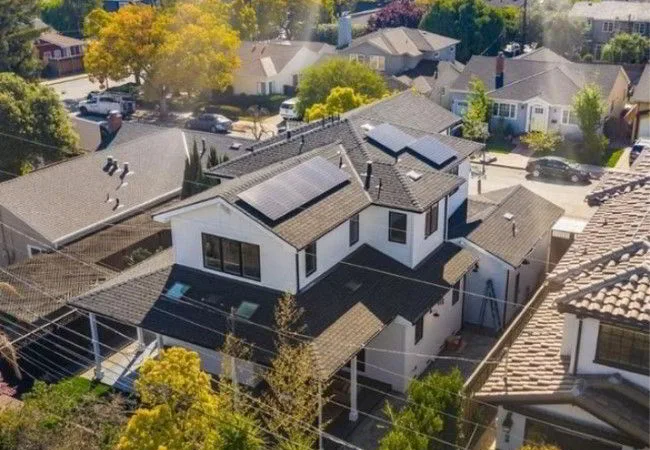 residential home with solar panels aerial photo